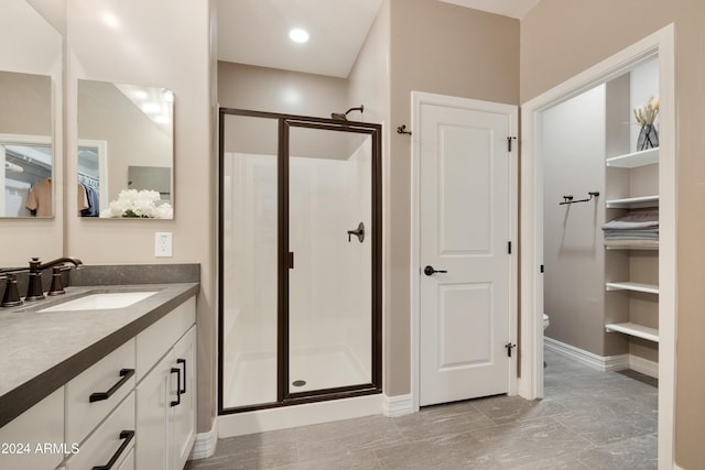 bathroom featuring vanity, toilet, and an enclosed shower