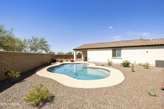 view of swimming pool with a patio area and cooling unit