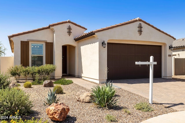 mediterranean / spanish-style house with a garage