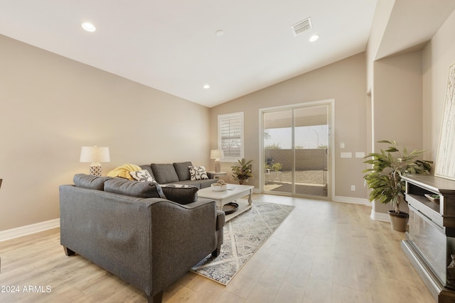 living room with light wood-type flooring and lofted ceiling