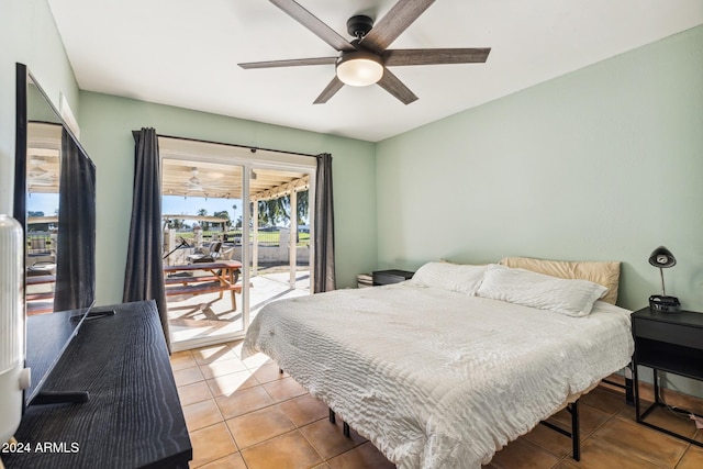 bedroom with light tile patterned floors, ceiling fan, and access to exterior