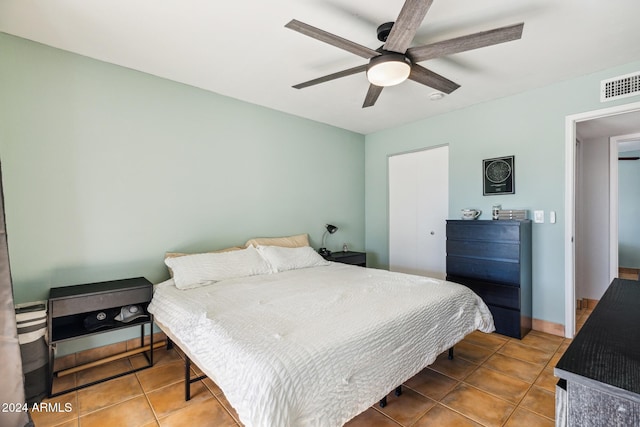 bedroom with ceiling fan and tile patterned floors