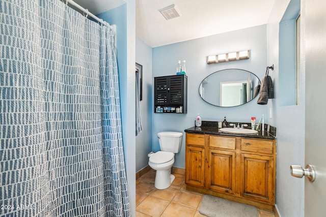 bathroom featuring toilet, a shower with curtain, vanity, and tile patterned flooring