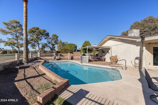 view of swimming pool with a patio area