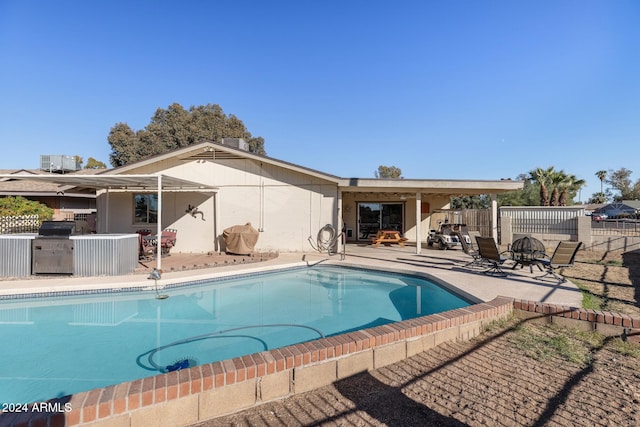 view of swimming pool with a patio