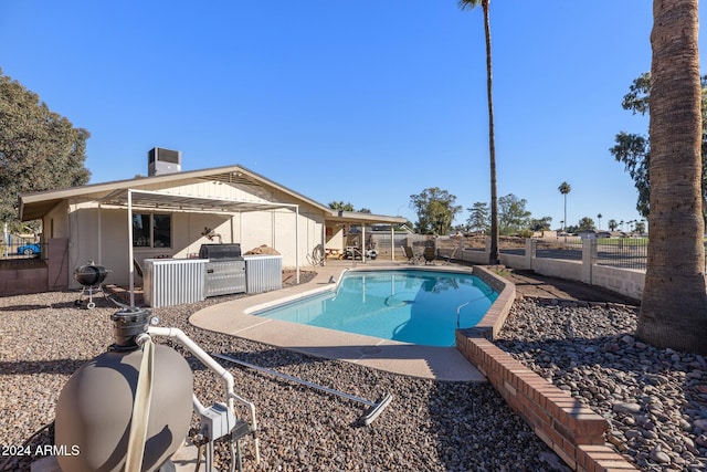 view of swimming pool with area for grilling and a patio