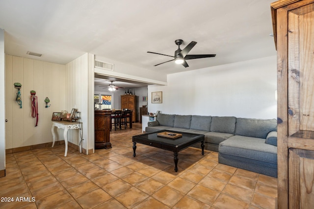 tiled living room with ceiling fan