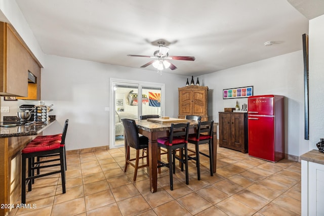 dining room with light tile patterned floors and ceiling fan