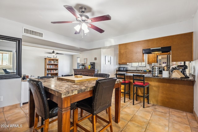 kitchen featuring kitchen peninsula, sink, ceiling fan, and light tile patterned floors