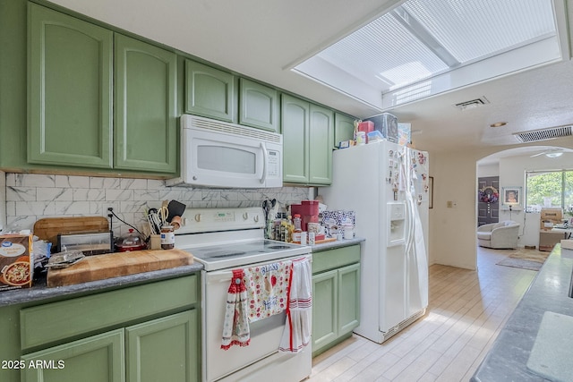 kitchen with white appliances, visible vents, decorative backsplash, and green cabinets
