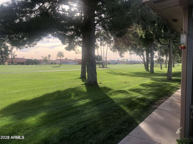 surrounding community with a yard and a residential view