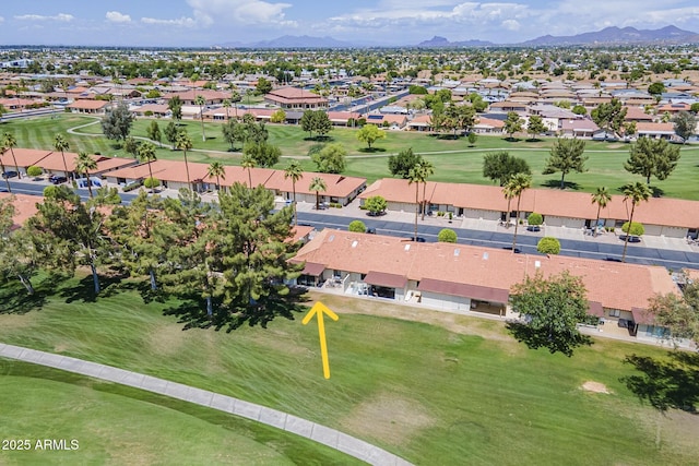 drone / aerial view featuring a mountain view, golf course view, and a residential view