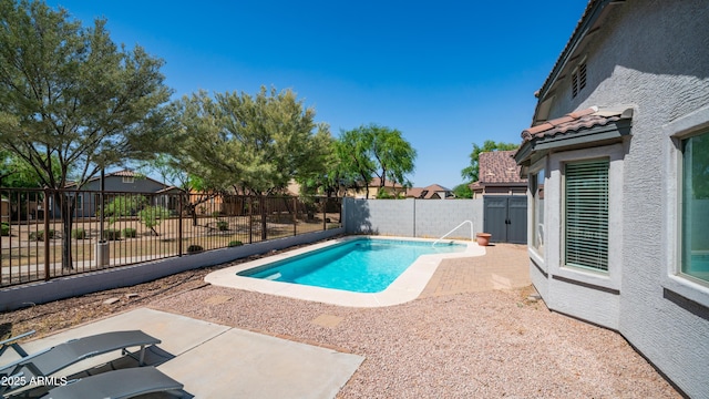 view of swimming pool featuring a fenced backyard and a patio area