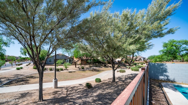 view of home's community with fence and a residential view