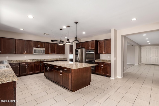 2920 E Virginia St E, Mesa, AZ 85213 - kitchen with appliances with stainless steel finishes, a center island, dark brown cabinetry, recessed lighting, and light stone countertops