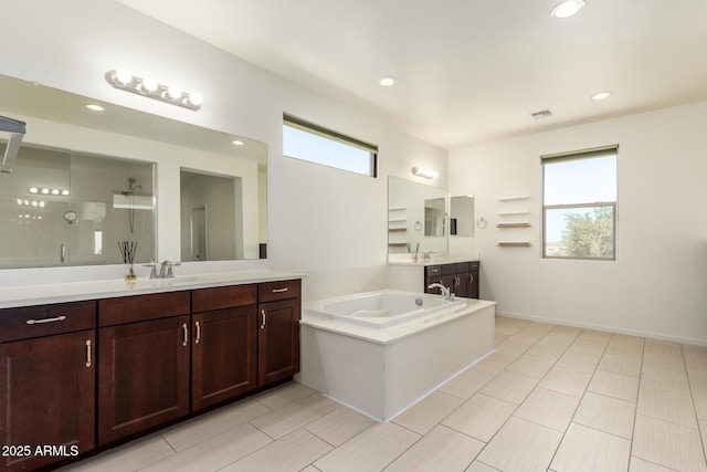 2920 E Virginia St E, Mesa, AZ 85213 - bathroom featuring a stall shower, two vanities, a bath, and recessed lighting