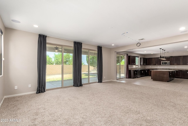 2920 E Virginia St E, Mesa, AZ 85213 - unfurnished living room featuring light carpet, baseboards, and recessed lighting