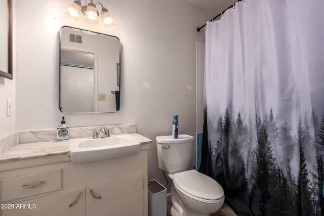 bathroom featuring vanity, toilet, and curtained shower