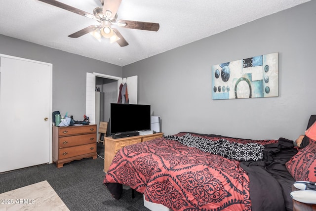 carpeted bedroom featuring ceiling fan and a textured ceiling