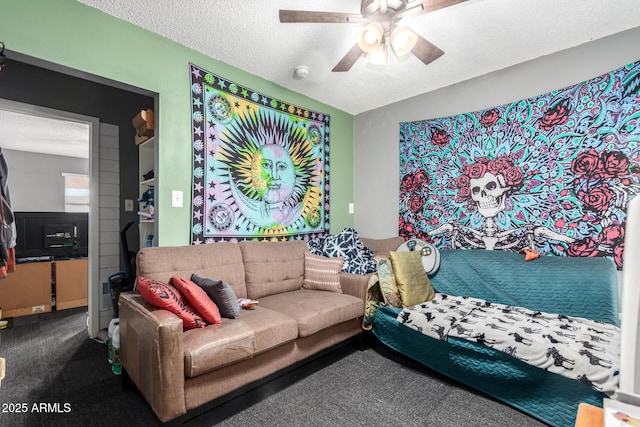 living room featuring ceiling fan, a textured ceiling, and carpet