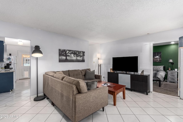 living room featuring a textured ceiling and light tile patterned flooring