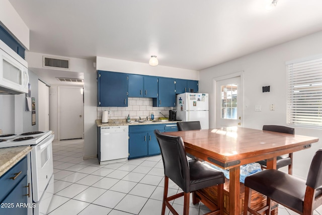 kitchen featuring white appliances, blue cabinets, sink, backsplash, and light tile patterned flooring