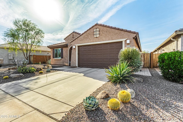 view of front facade with a garage, driveway, a tile roof, and stucco siding