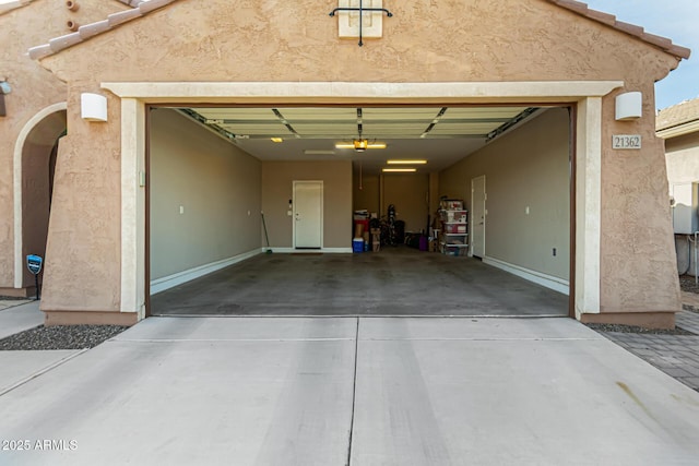 garage featuring driveway and a garage door opener