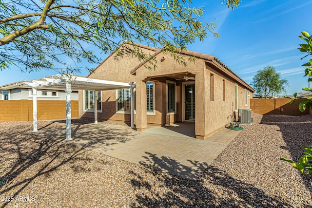 rear view of house with a fenced backyard, a tile roof, a patio area, a pergola, and stucco siding