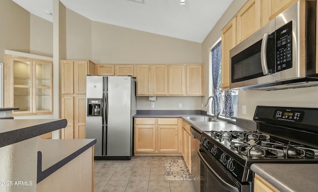 kitchen with light tile patterned floors, sink, stainless steel appliances, high vaulted ceiling, and light brown cabinetry