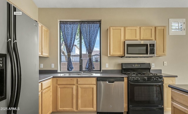 kitchen with sink, light brown cabinets, and appliances with stainless steel finishes