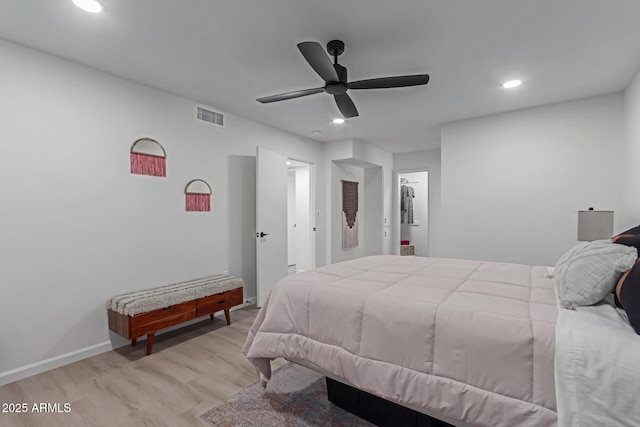 bedroom with ceiling fan, a closet, and light hardwood / wood-style flooring