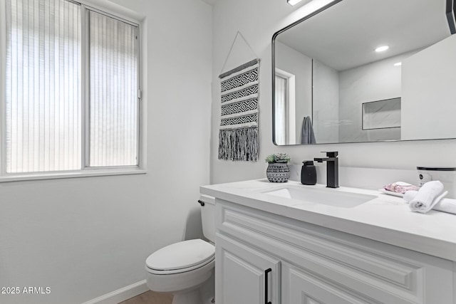 bathroom featuring toilet and vanity