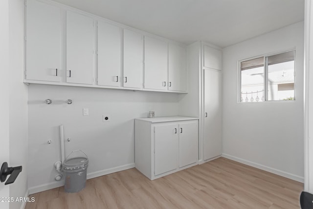 washroom with light hardwood / wood-style flooring, cabinets, washer hookup, hookup for an electric dryer, and gas dryer hookup