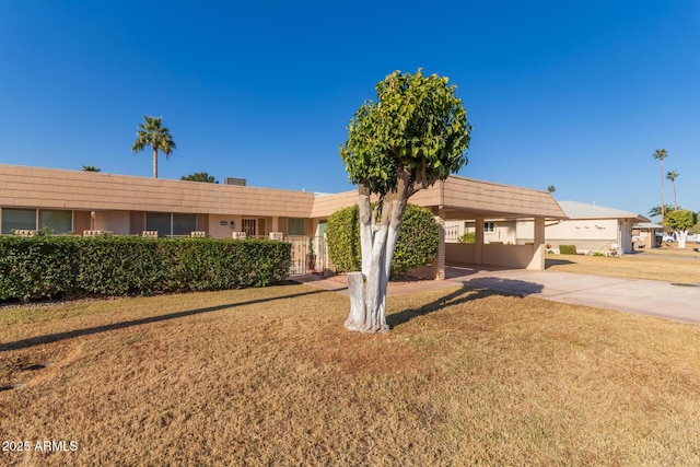 single story home with a front yard and a carport