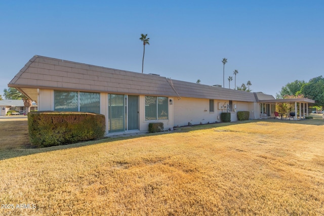 back of house featuring a yard and central air condition unit