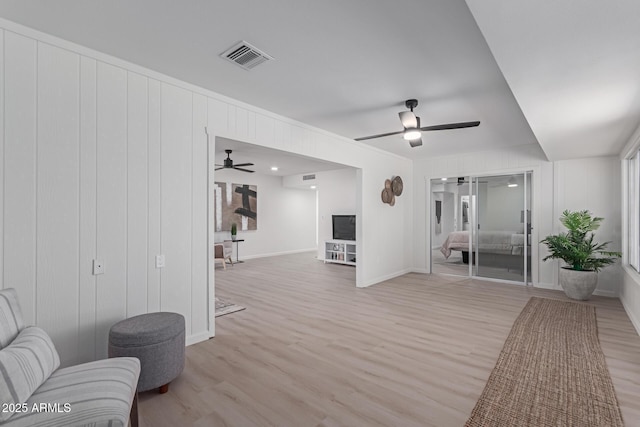 sitting room with ceiling fan and light hardwood / wood-style flooring