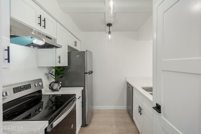 kitchen featuring light stone counters, white cabinets, pendant lighting, and appliances with stainless steel finishes