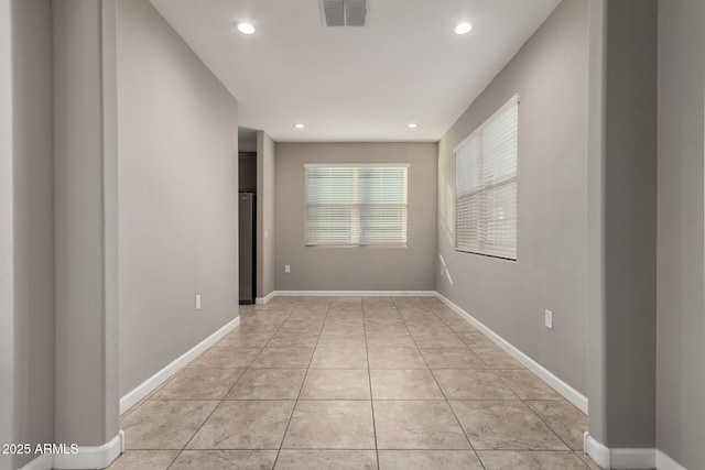 spare room with recessed lighting, baseboards, visible vents, and light tile patterned flooring