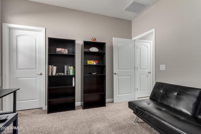 living area with carpet floors and visible vents