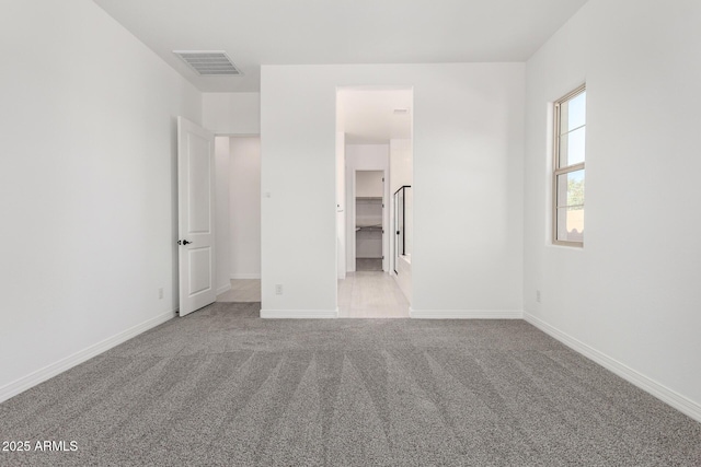 unfurnished bedroom featuring visible vents, baseboards, and carpet floors