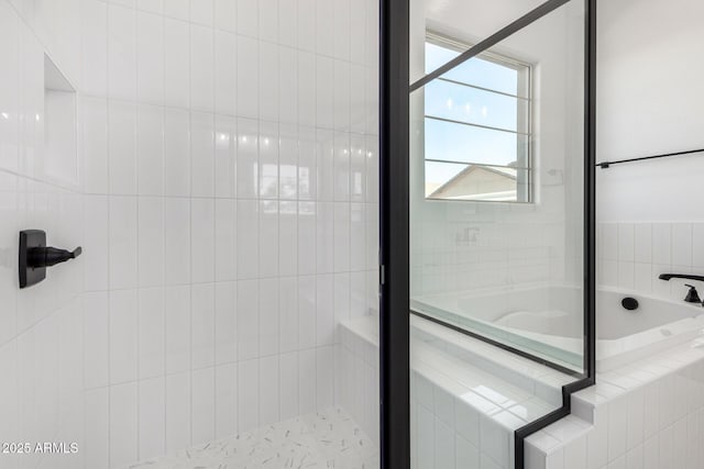 full bathroom with a bath and a shower stall