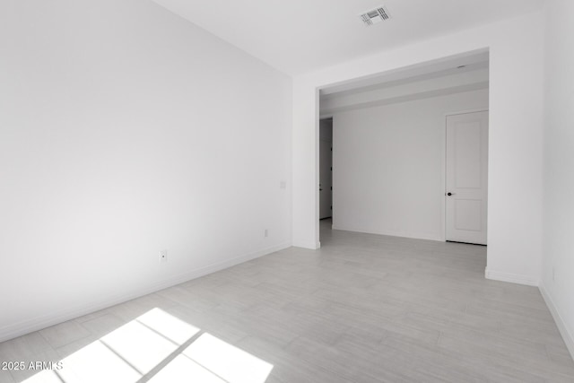 unfurnished room featuring visible vents and baseboards