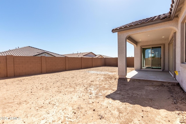 view of yard featuring a patio and a fenced backyard