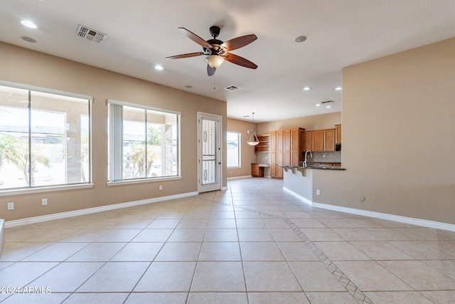 interior space with visible vents, a ceiling fan, recessed lighting, light tile patterned flooring, and baseboards