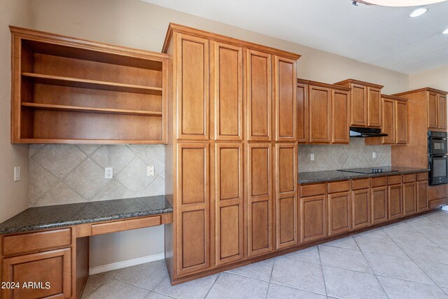 kitchen featuring dark stone counters, black electric stovetop, backsplash, and light tile patterned floors