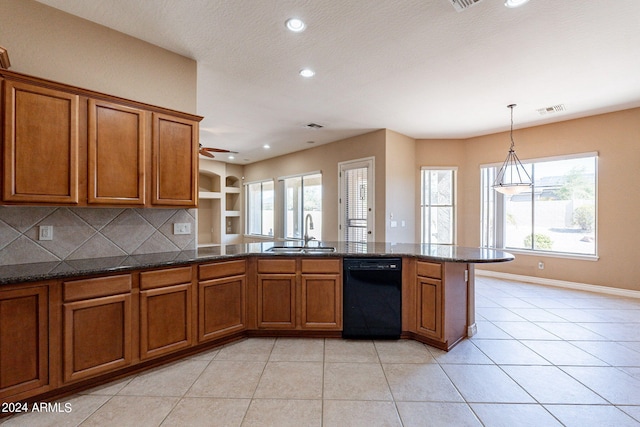 kitchen with visible vents, dishwasher, light tile patterned floors, brown cabinets, and a sink