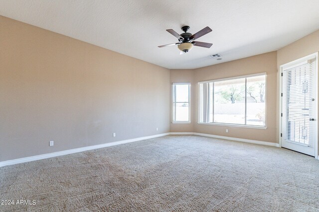 carpeted empty room featuring a textured ceiling and ceiling fan