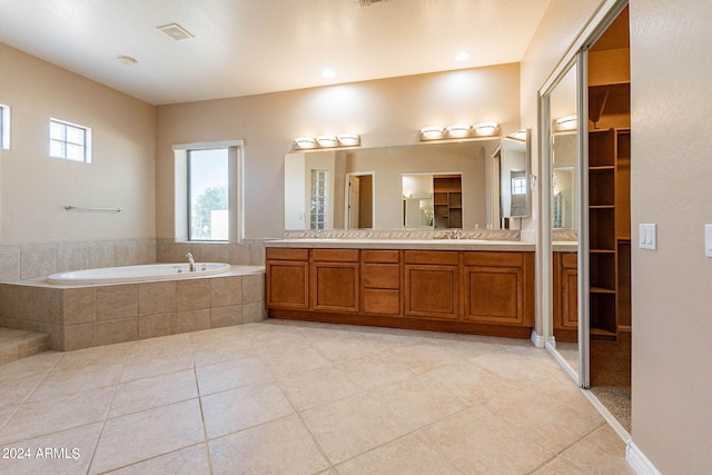 bathroom with a bath, visible vents, tile patterned floors, and vanity