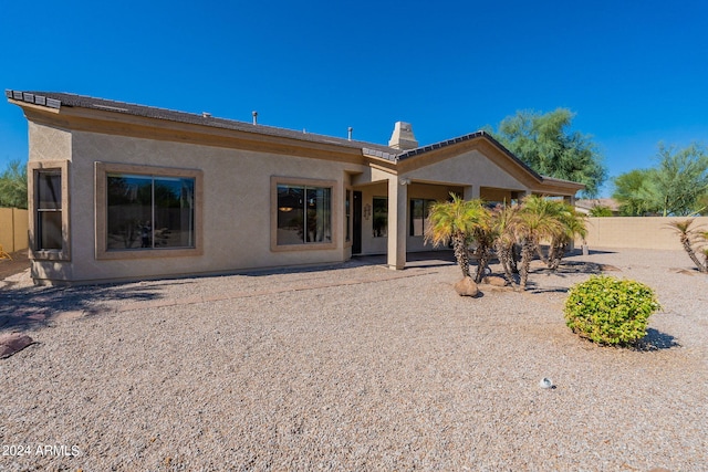 back of property featuring stucco siding, a patio area, and fence